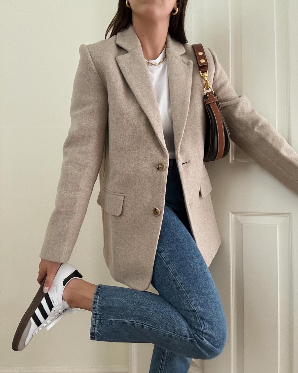 Semi Casual Clothes: 31 Outfit Ideas From Dresses to Loafers 18 Person wearing a beige blazer, white t-shirt, blue jeans, and white sneakers.