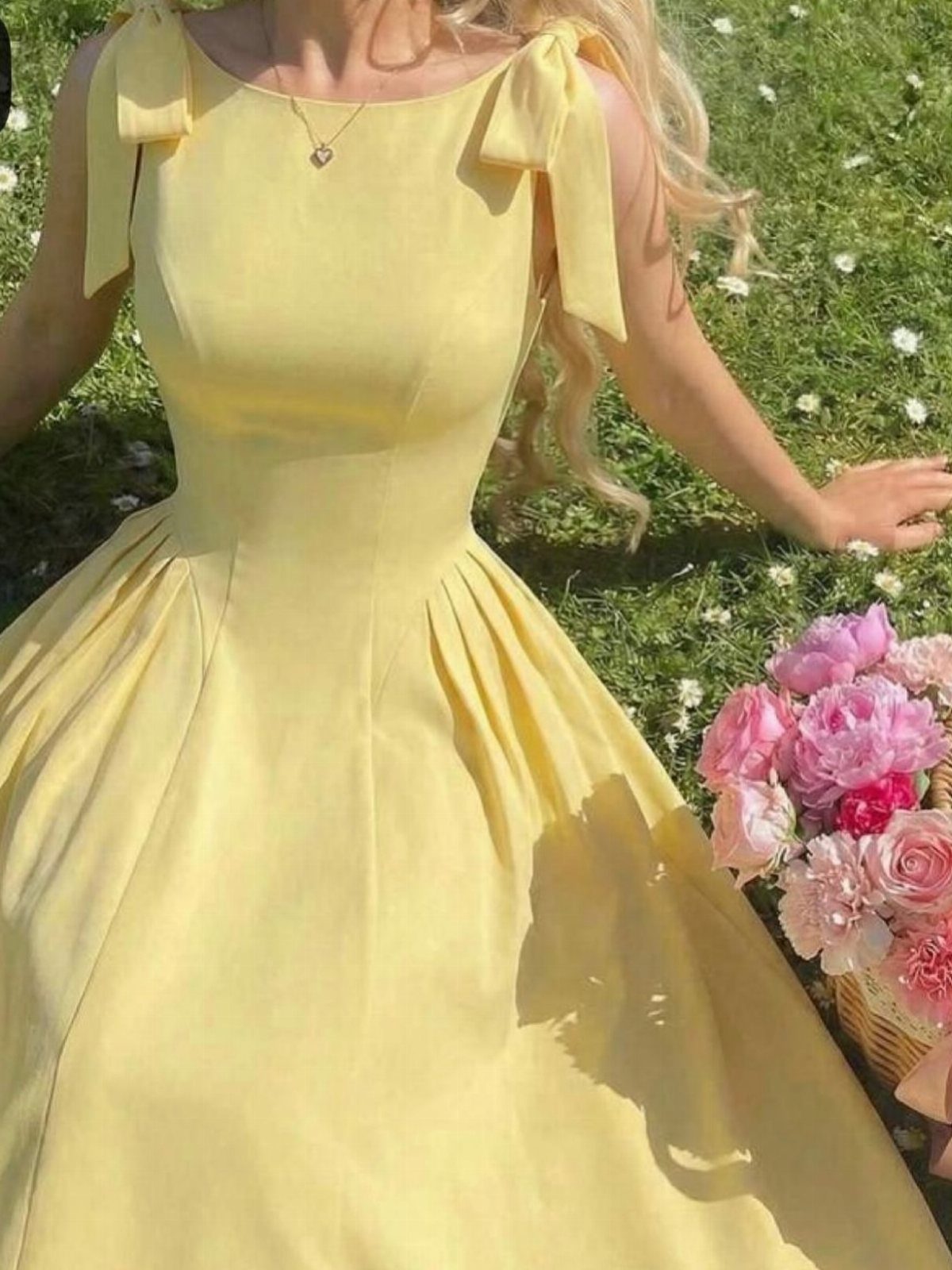 Semi Casual Clothes: 31 Outfit Ideas From Dresses to Loafers 6 Yellow sleeveless dress with shoulder bows worn by a person in a grassy field.