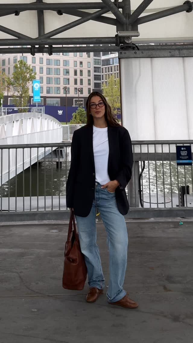 Semi Casual Clothes: 31 Outfit Ideas From Dresses to Loafers 12 Woman wearing a black blazer, white shirt, and light blue jeans with brown bag.