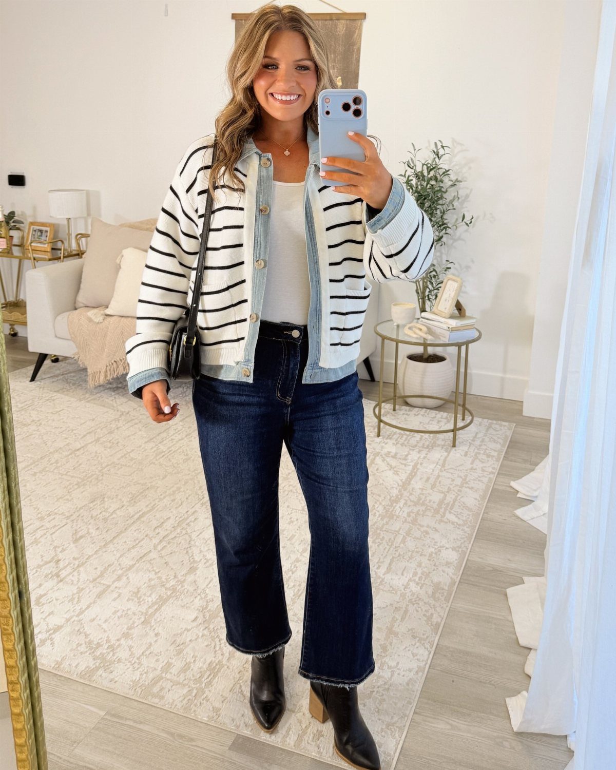 Semi Casual Clothes: 31 Outfit Ideas From Dresses to Loafers 4 Woman wearing a striped jacket and dark wide-leg jeans in a bright room.