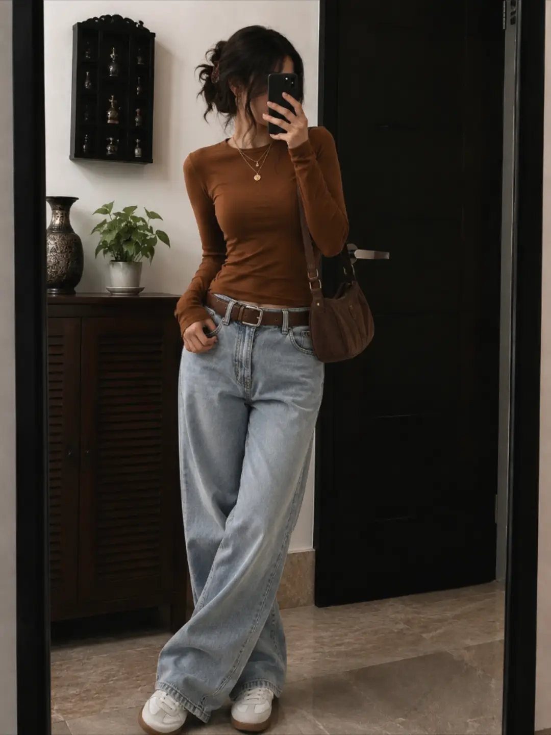 Semi Casual Clothes: 31 Outfit Ideas From Dresses to Loafers 13 Woman wearing a fitted brown long-sleeved top and wide-leg light blue jeans.