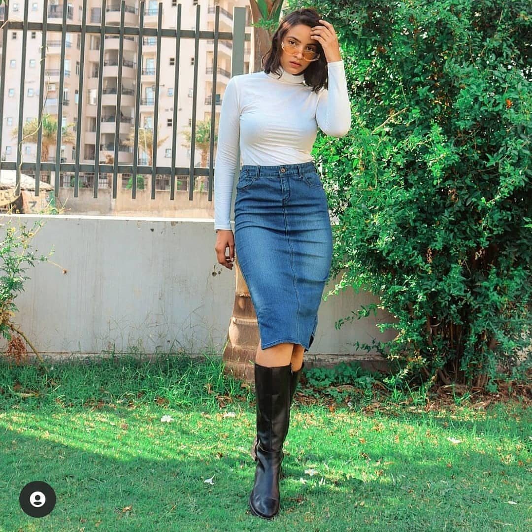 Semi Casual Clothes: 31 Outfit Ideas From Dresses to Loafers 5 Woman wearing a white turtleneck, blue denim knee-length skirt, and black boots outdoors.