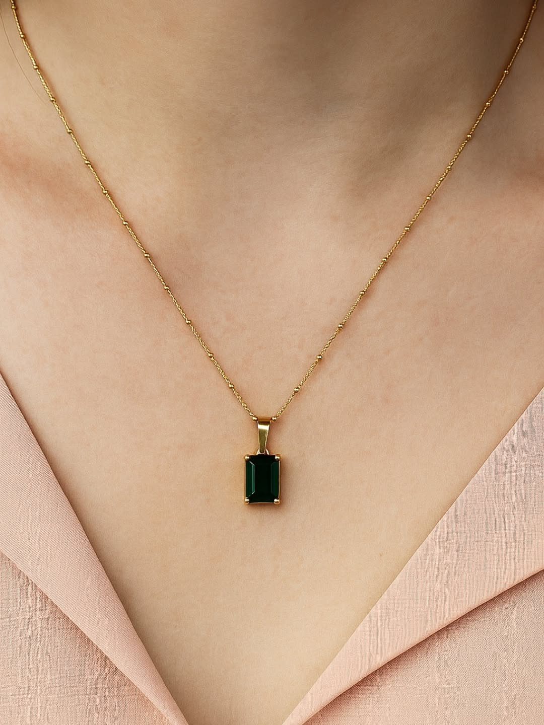 Semi Casual Clothes: 31 Outfit Ideas From Dresses to Loafers 26 Gold pendant necklace with a green emerald stone worn over a pink blouse.