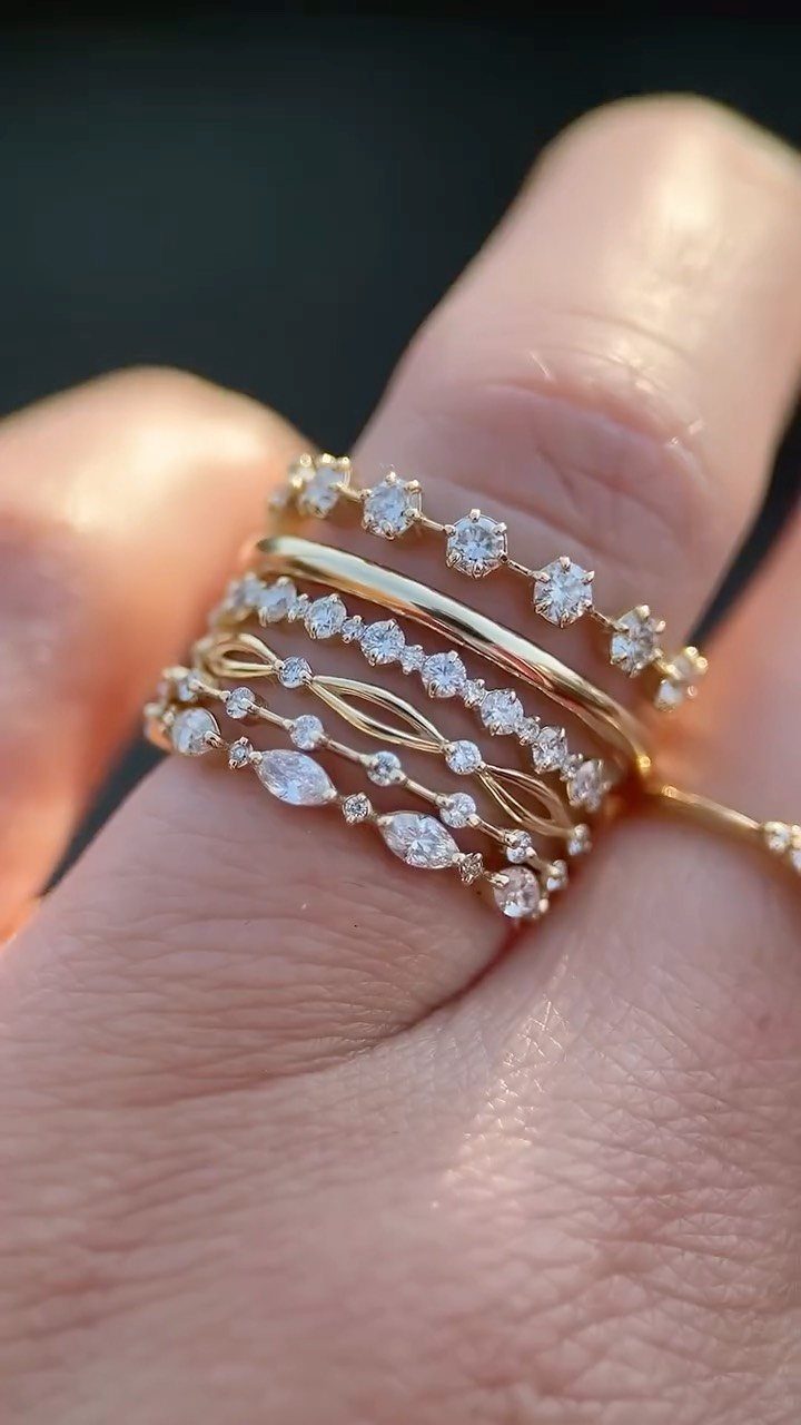 Semi Casual Clothes: 31 Outfit Ideas From Dresses to Loafers 27 Multiple gold rings with diamonds stacked on a person's finger in a close-up shot.