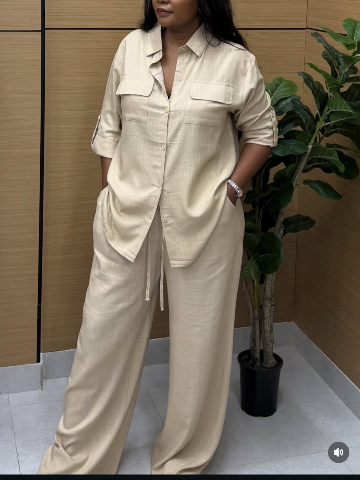 Semi Casual Clothes: 31 Outfit Ideas From Dresses to Loafers 11 Woman wearing a beige two-piece set with a button-down shirt and wide-leg trousers.