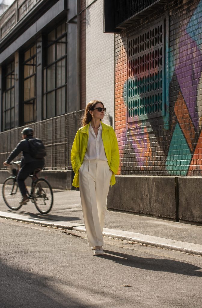Model wearing a colorful oversized windbreaker with funnel collar.