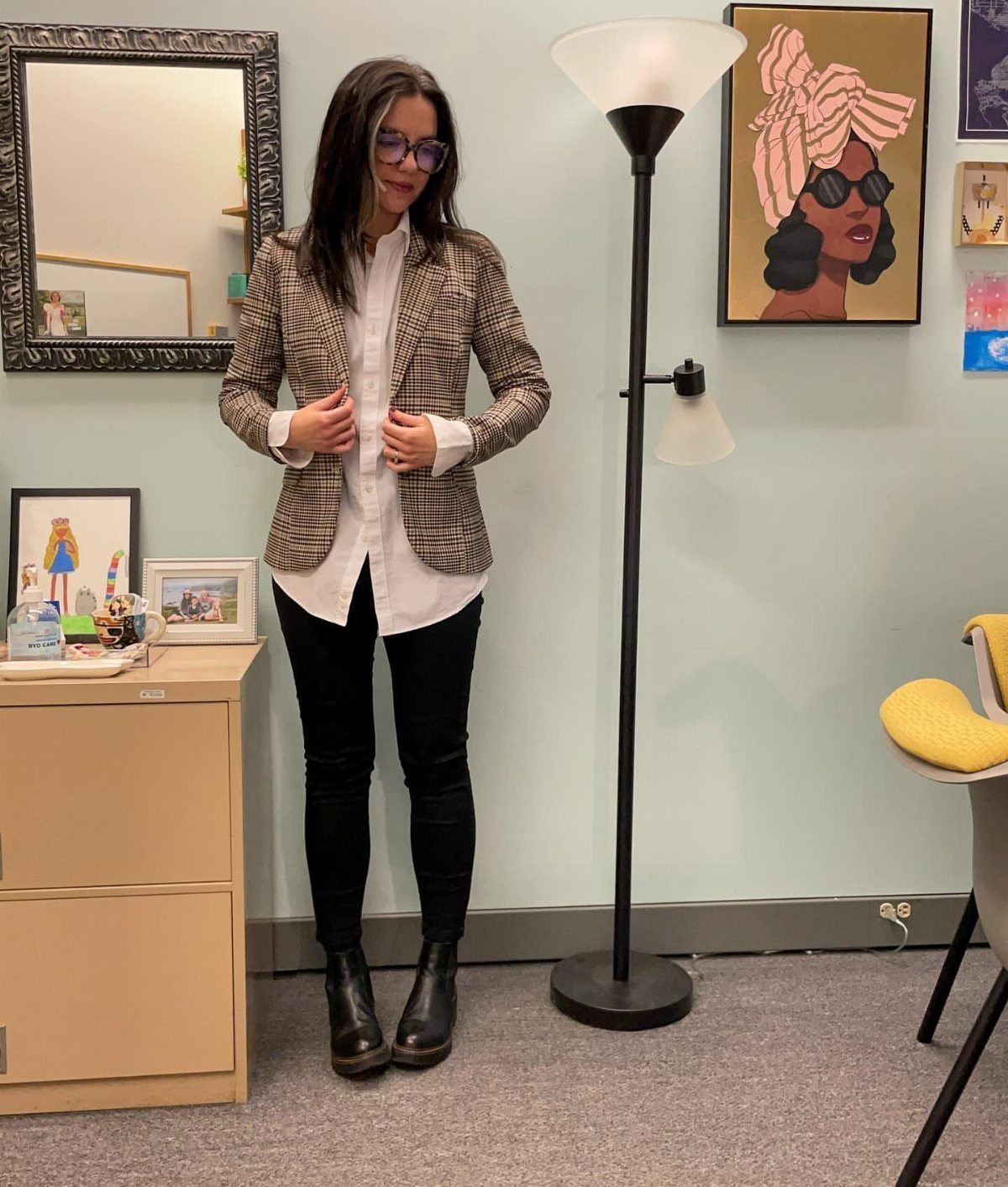Woman wearing black Chelsea boots and skinny jeans with a patterned blazer.