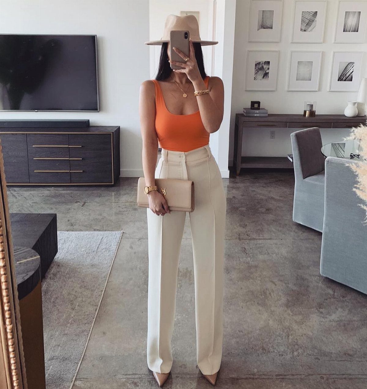Tan Linen Pants Outfit Ideas for Women: 11 Looks to Try 2 Woman in orange tank top and off-white linen pants wearing a tan hat.
