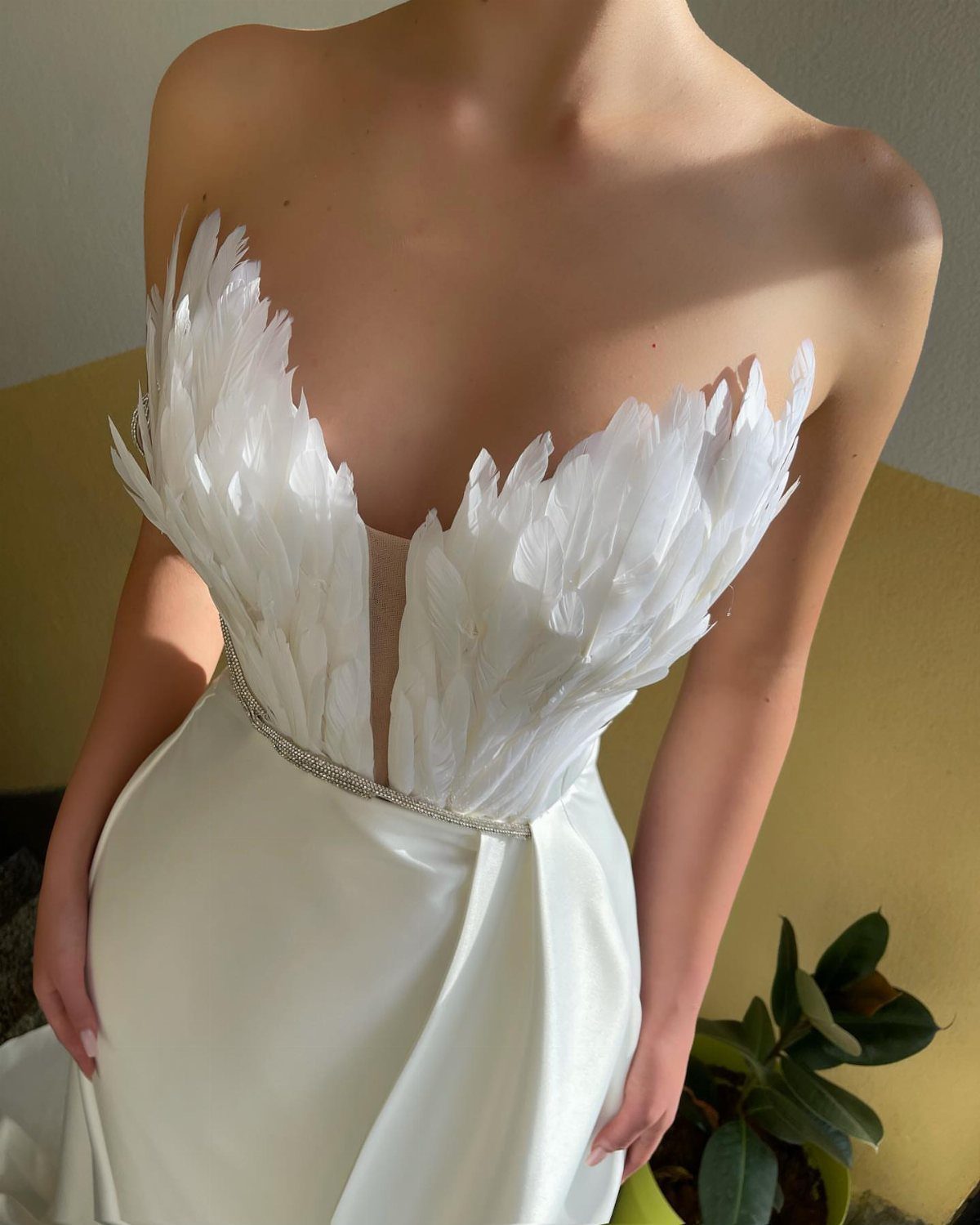 14 White Feather Gown Ideas, From Bridal Capes to Tea-Length 7 White off-the-shoulder gown with a feathered bodice and a sparkling rhinestone waist belt
