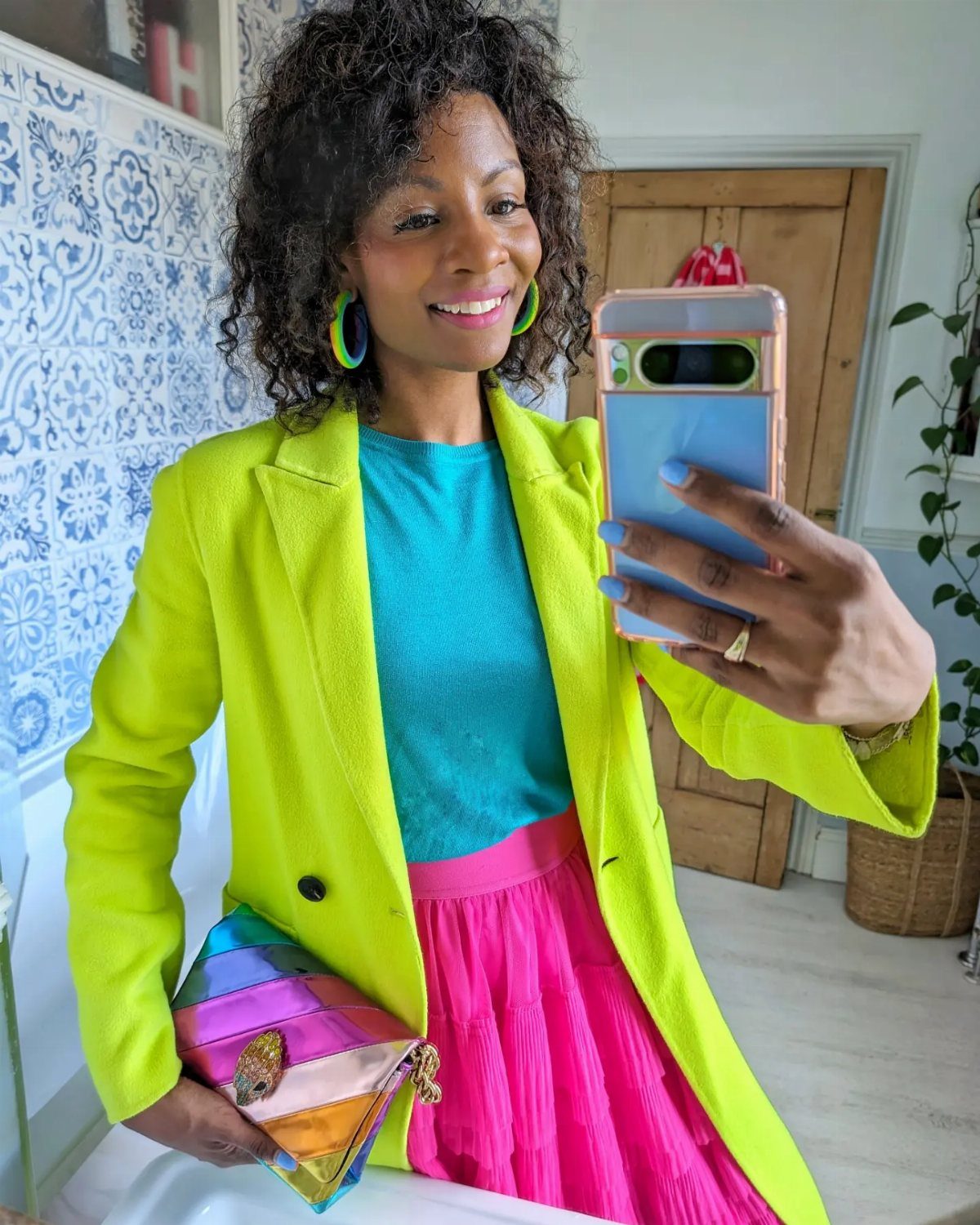 Women Outfit Work Office: 17 Ideas to Refresh Your Look 18 Woman in neon yellow blazer, turquoise top, and pink skirt holding a colorful clutch.