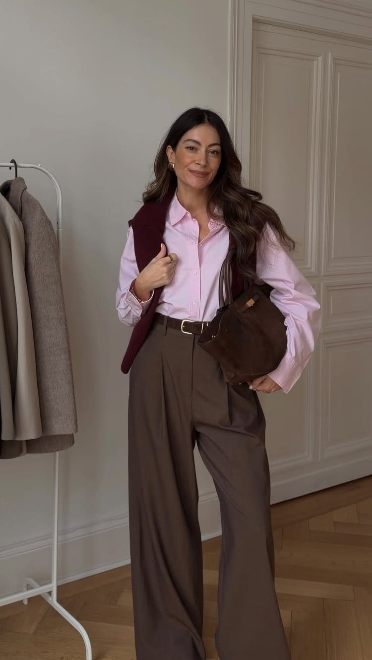 Women Outfit Work Office: 17 Ideas to Refresh Your Look 14 Woman wearing a pink shirt, burgundy vest, and brown wide-leg trousers for office work.