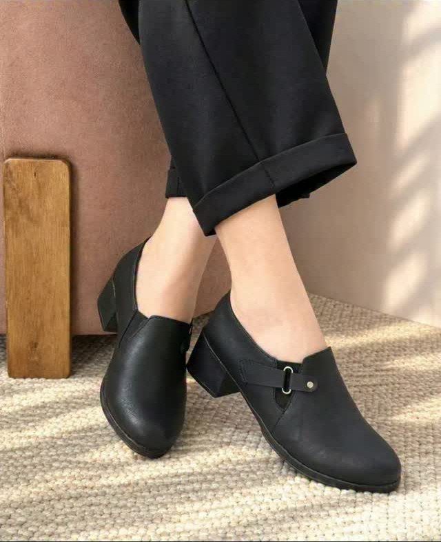 Women Outfit Work Office: 17 Ideas to Refresh Your Look 15 Black leather low-block heel shoes worn with black trousers on a textured carpet.