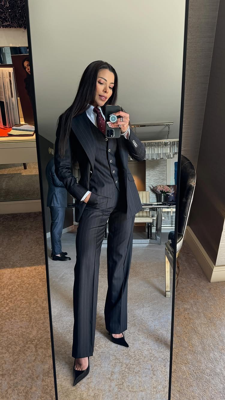 Women Outfit Work Office: 17 Ideas to Refresh Your Look 16 Woman in a dark pinstripe three-piece suit with a red tie and black heels.